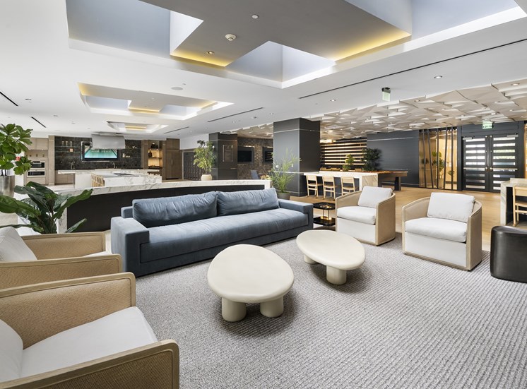 A modern living room with a grey carpet and furniture.